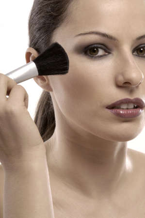 woman using make-up brushの写真素材