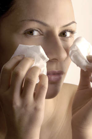Woman cleaning her face with tissuesの写真素材