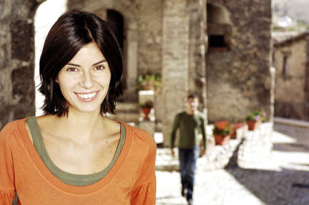 young woman with black hairs smilingの写真素材