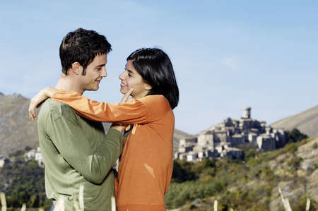llatin couple embracing in the fieldsの写真素材