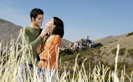 couple caressing in the fieldsの写真素材