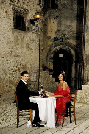 young couple sitting at a restaurantの写真素材