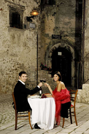 couple toasting at restaurantの写真素材