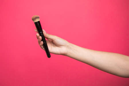 female hand with a brush for makeupの写真素材