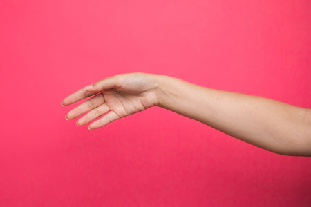 Female hand up on pink background