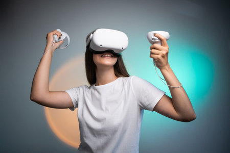 Portrait of young womans playing in VR-glasses colorful background. Concept of human emotions, facial expression, modern gadgets and technologies. Look like winner.の写真素材