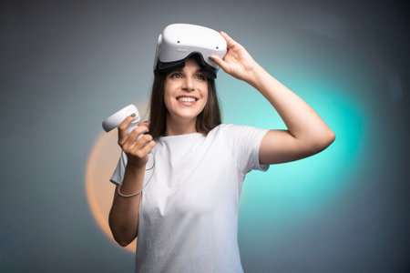 Happy woman using a virtual reality headset isolated on colorful backgroundの写真素材