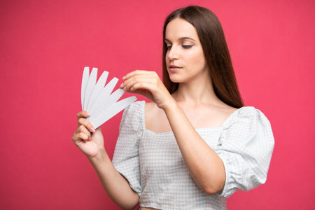 picture of young girl holding nail files and choosing one of themの写真素材