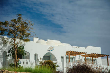 white house red sea in tropical resort whith palm and sandの写真素材