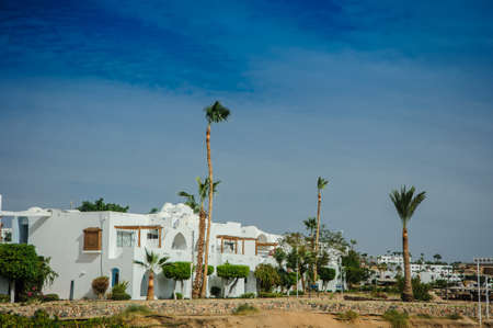 white house red sea in tropical resort whith palm and sandの写真素材