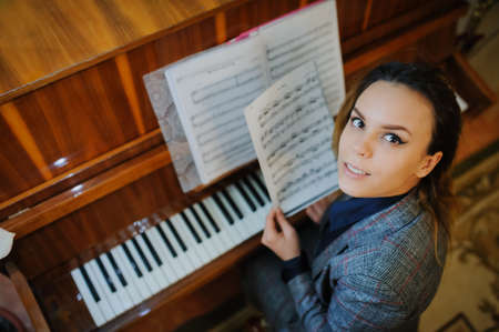 young woman play on piano notes music sound artの写真素材