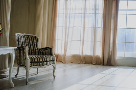 white vintage old studio room with two chairs and table with red flowersの写真素材