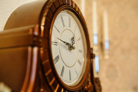 Antique wooden vintage wall clock isolated on backgrounの写真素材
