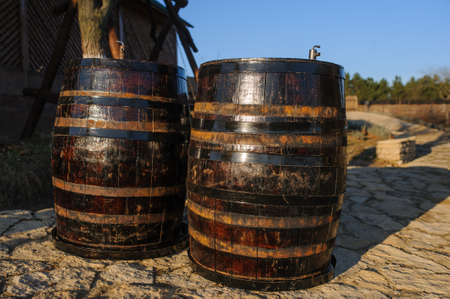 wood old wine barrel with steel ring backgroundの写真素材
