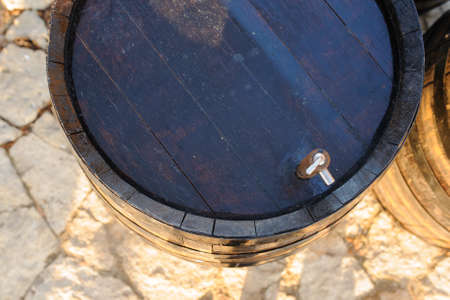 wood old wine barrel with steel ring backgroundの写真素材