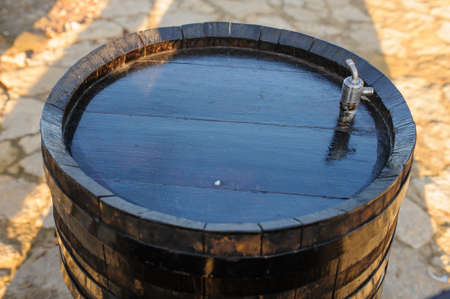 wood old wine barrel with steel ring backgroundの写真素材