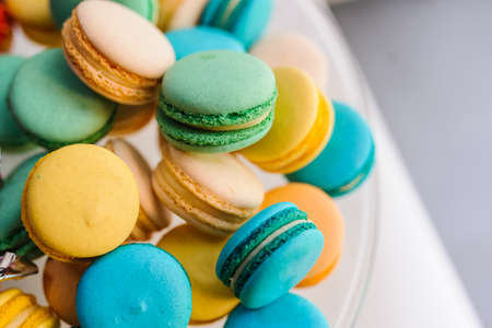Close up colorful macarons dessert with vintage pastel tones on white backgroundの写真素材