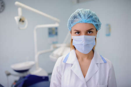 portrait of smile young woman dentist in dental treatment roomの写真素材