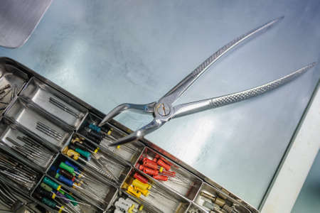 close up Dental extraction forceps on the dental burs and  endodontic equipmen の写真素材