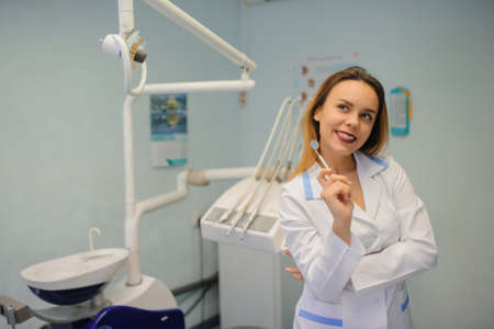 portrait of smile young female dentist in dental treatment roomの写真素材