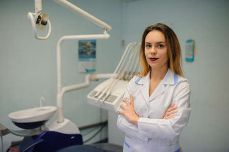 portrait of smile young woman dentist in dental treatment roomの写真素材