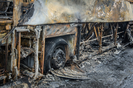 Burnt bus is seen on the street after caught in fire during travel, after fire