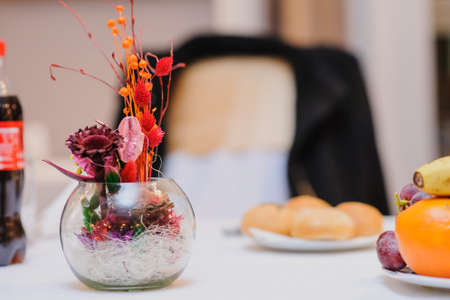 Bouquet of dried flowers in vase on light backgroundの写真素材