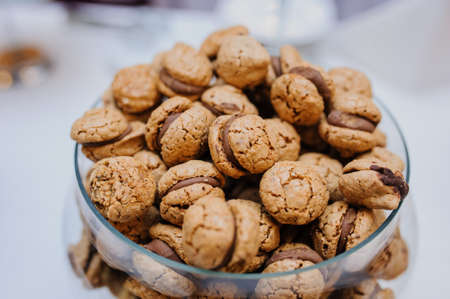 Sandwich cookies with chocolate cream in the middle in a  glass bowlの写真素材