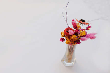 Bouquet of dried flowers in vase on light background top view

の写真素材