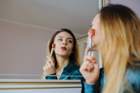 portrait in mirror of sexy smiling young woman model with glamour red lips, bright makeup, perfect...