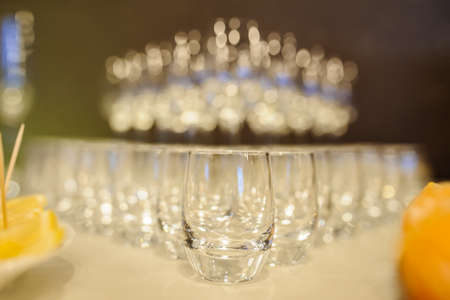 A lot of wine glasses arranged in a row. Compostition in restaurantの写真素材