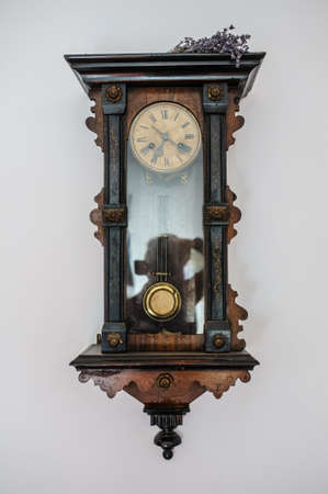 Antique old vintage wooden wall clock. Interesting viewの写真素材