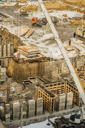 Tower crane bucket full of concrete liquid is delivering to the site. の写真素材