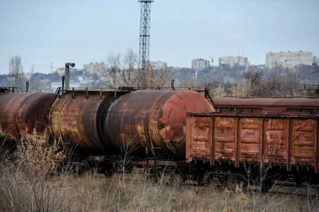 Abandoned rusty railway containers for as and oil transportation. Abstract train transport. Vintage style.の写真素材