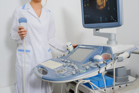 Ultrasound examination. Doctor keep holding in her hand an ultrasound transducer. Close up.USG...