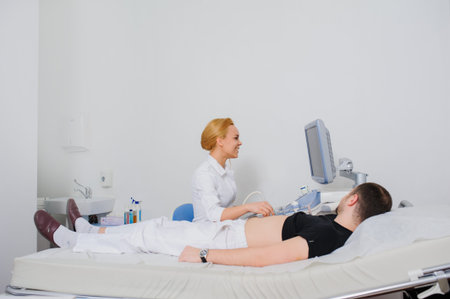 Smiling female doctor ultrasound examine a patient abdomen at the hospital. USG 