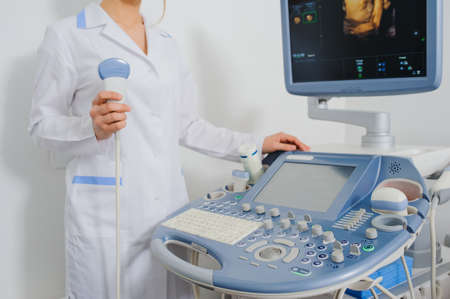 Ultrasound examination. Doctor keep holding in her hand an ultrasound transducer. Close up.
USG machine の写真素材