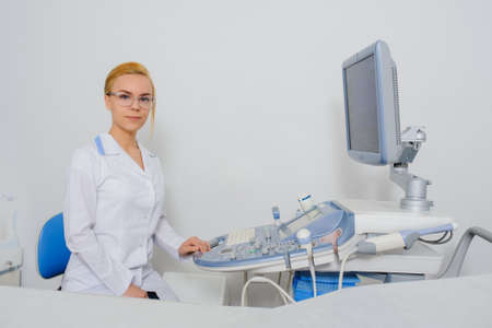portrait of young beautiful woman doctor working at ultrasound diagnostic machine usg.の写真素材