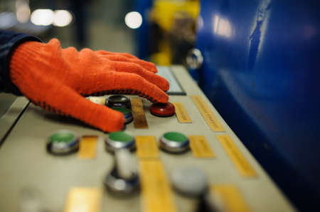 close up operator hand at metal roof forming machineの写真素材
