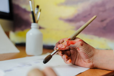 Female hand artist paint with brush a new pictureの写真素材