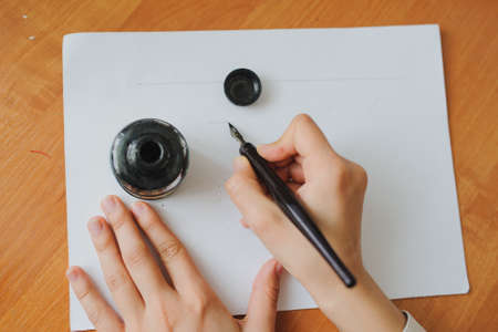 Female hand artist paint with ink a new pictureの写真素材