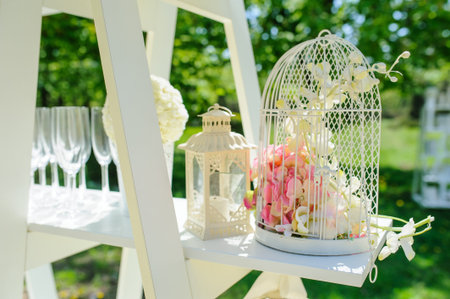 Wedding composition decoration with white roses in a metal bucket and cageの写真素材