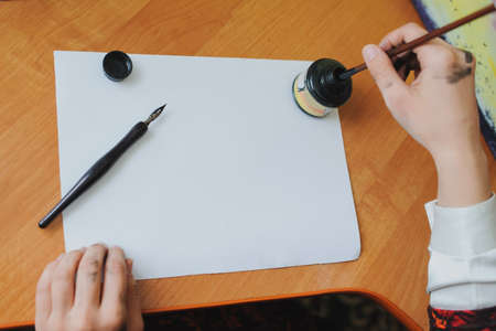 Female artist paint hand writing chinese calligraphyの写真素材