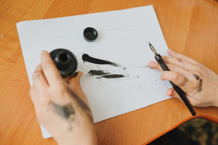 Female hand artist paint with ink a new pictureの写真素材