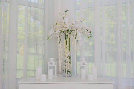 Wedding decorations with flowers ceremony and seating guests in white romantic styleの写真素材