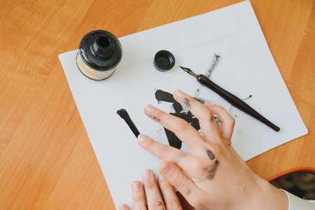 Female artist paint hand writing chinese calligraphyの写真素材