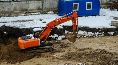 excavator on tracks at the mountain road constructionの写真素材