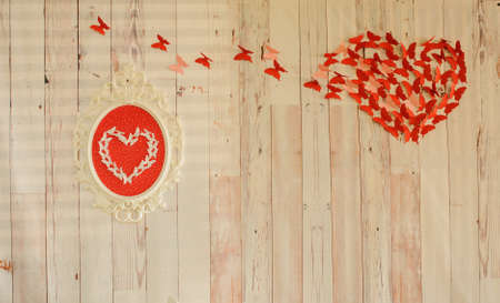 Love background. Red heart from red paper, wood wall background. Symbol of love on wall. valentines garlandの写真素材