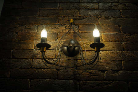 Decorative antique vintage style light bulbs against brick wall backgroundの写真素材