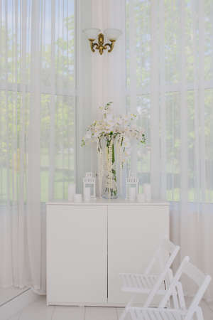 Wedding decorations with flowers ceremony and seating guests in white romantic styleの写真素材